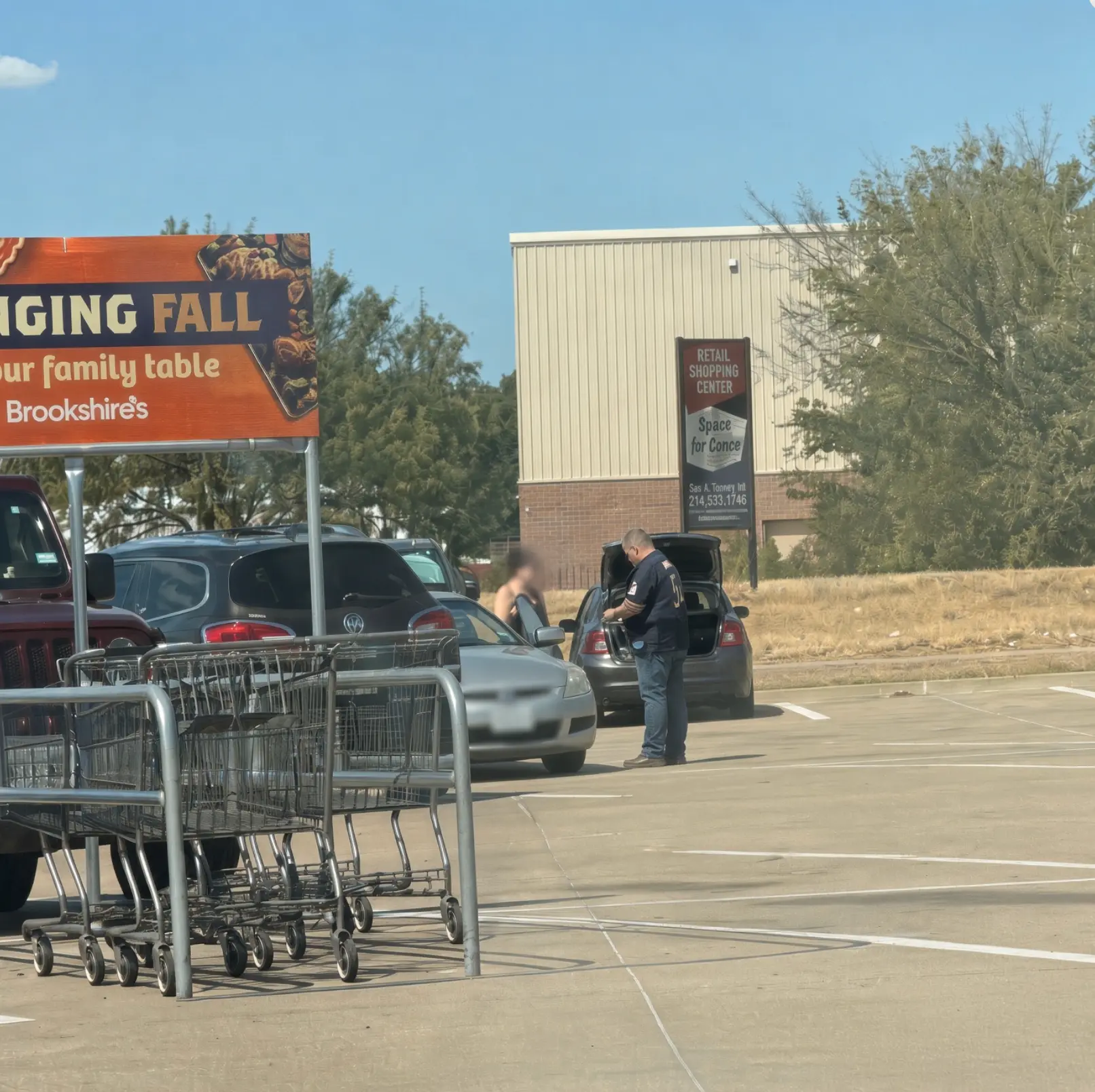 Groceries being loaded into a car outside a grocery store